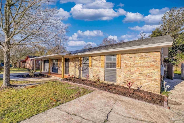 ranch-style home with brick siding and a front yard