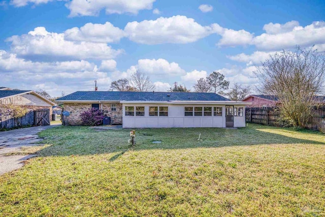 view of front of home with a front lawn and fence