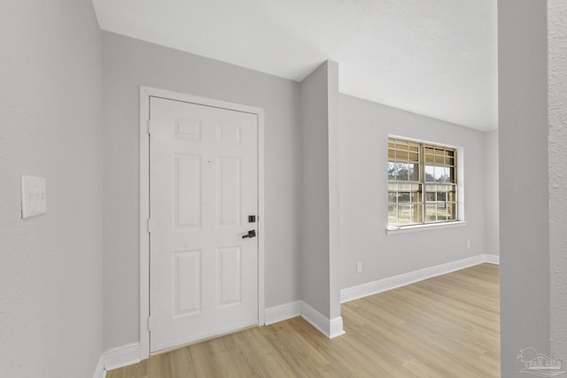 foyer featuring light wood finished floors and baseboards