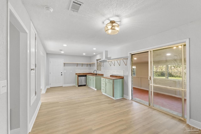 kitchen featuring visible vents, wooden counters, light wood-style flooring, dishwasher, and green cabinets