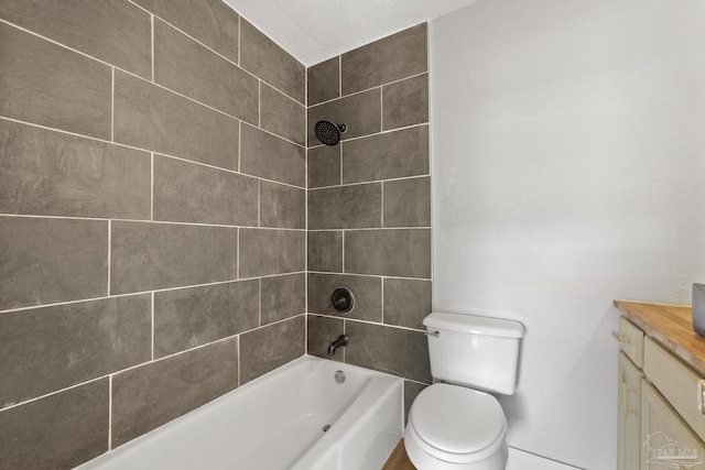 bathroom with shower / tub combination, vanity, and toilet