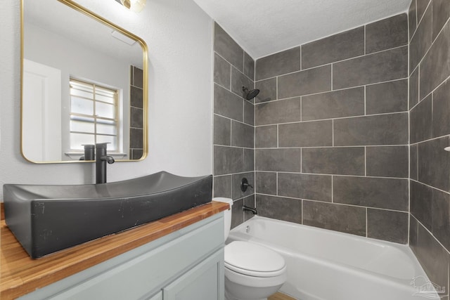 bathroom with vanity, toilet, and bathing tub / shower combination