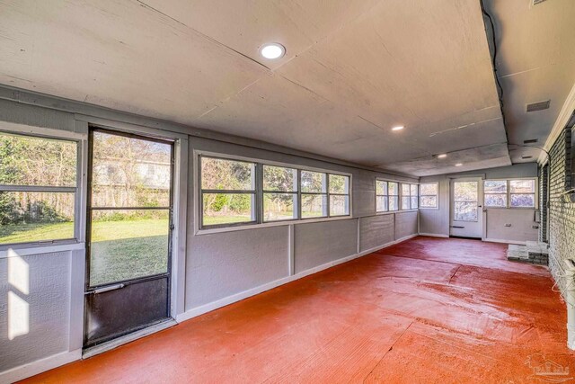 unfurnished sunroom featuring visible vents and lofted ceiling