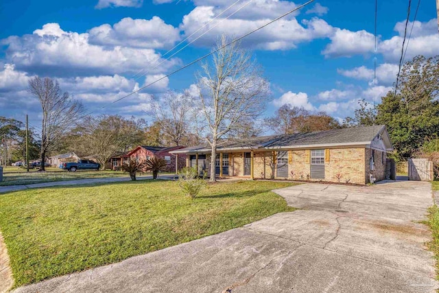 single story home featuring brick siding, concrete driveway, and a front lawn