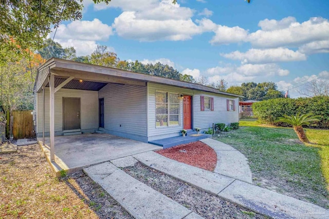 ranch-style home with a front yard and a carport