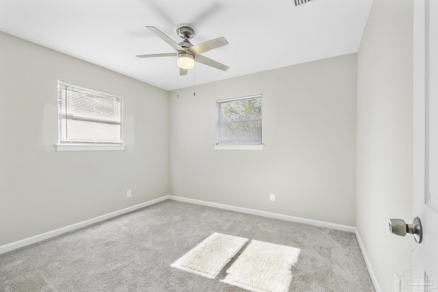 carpeted spare room featuring ceiling fan