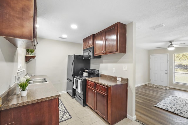 kitchen with ceiling fan, sink, light hardwood / wood-style flooring, a textured ceiling, and black appliances