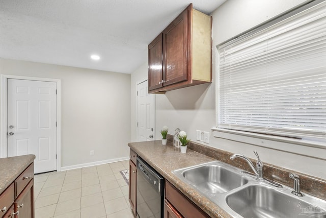 kitchen with dishwasher, light tile patterned floors, and sink