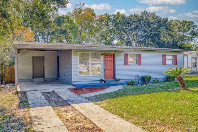 ranch-style home with a front yard and a carport