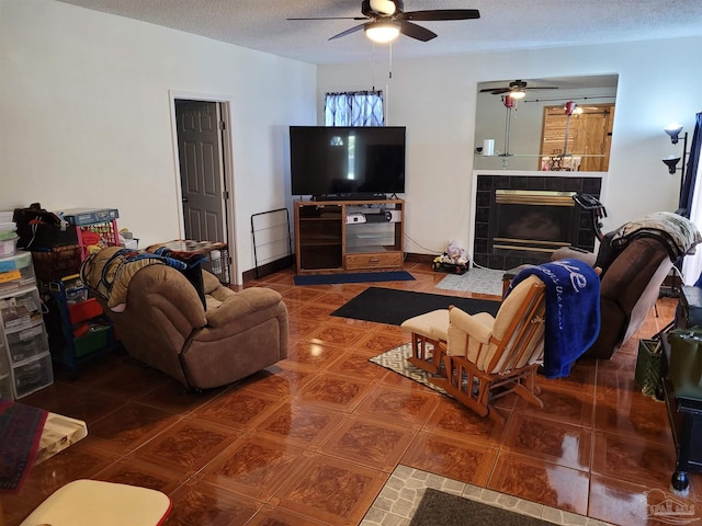 tiled living room with a textured ceiling and a tiled fireplace