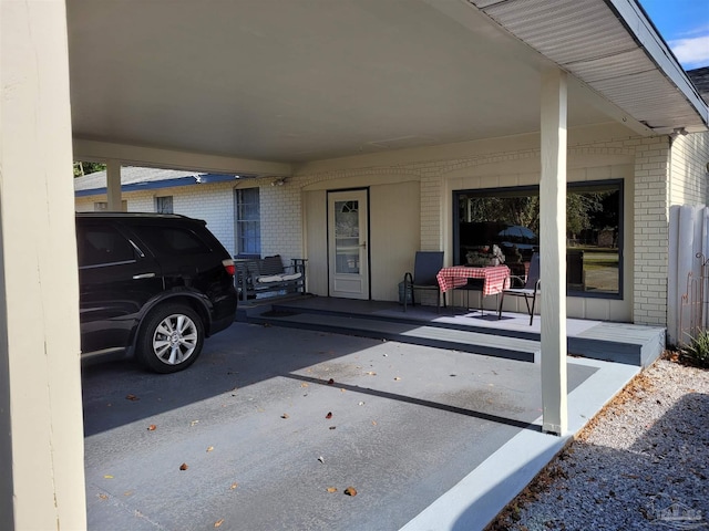 view of patio / terrace with covered porch and a carport