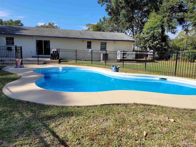 view of swimming pool with a patio area and a yard
