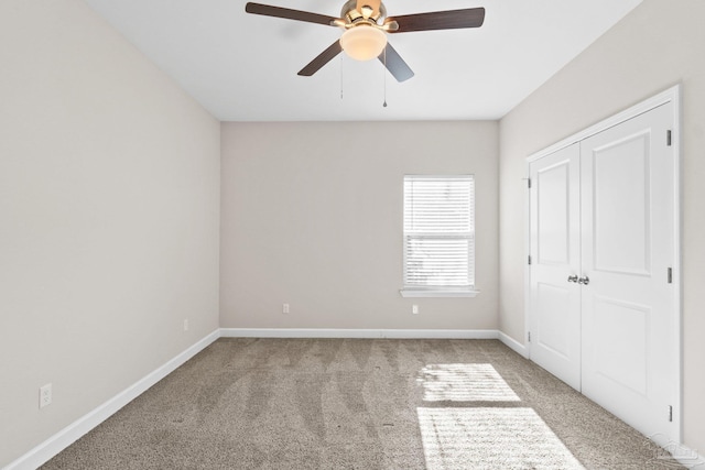 unfurnished bedroom with light carpet, a closet, and ceiling fan