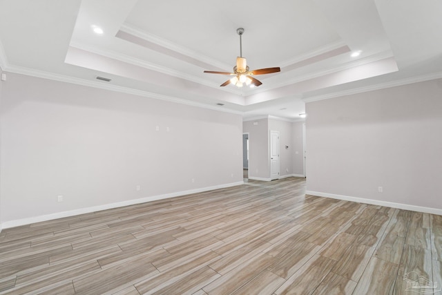 unfurnished room featuring crown molding and a tray ceiling