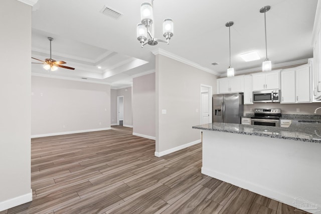 kitchen featuring hardwood / wood-style floors, white cabinets, sink, ornamental molding, and appliances with stainless steel finishes