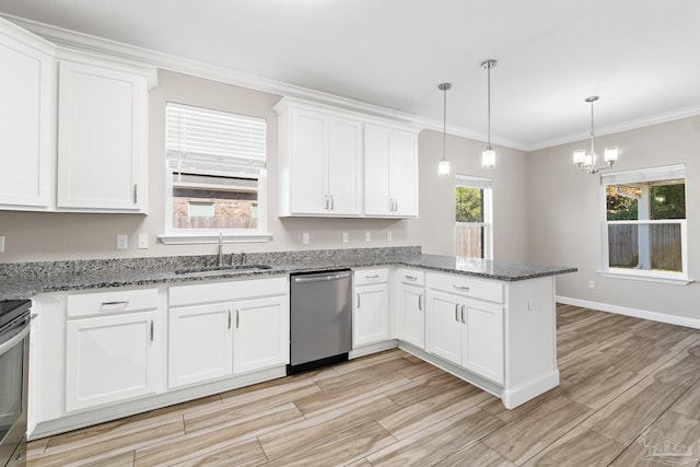 kitchen featuring stainless steel dishwasher, hanging light fixtures, a healthy amount of sunlight, and sink