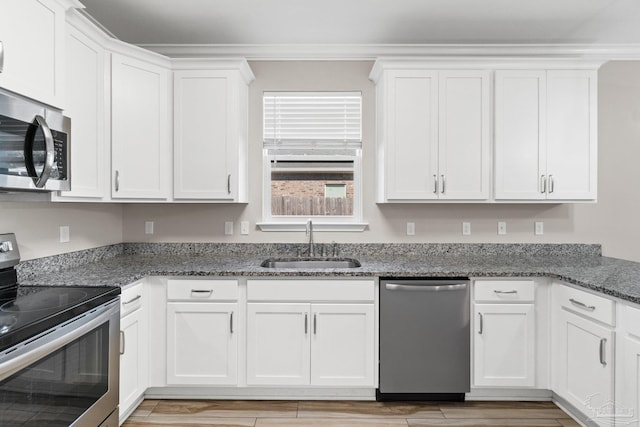 kitchen featuring light hardwood / wood-style flooring, stainless steel appliances, white cabinetry, and sink