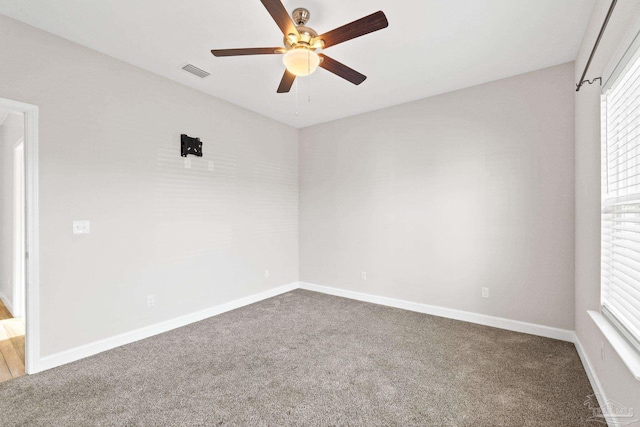 carpeted empty room featuring ceiling fan