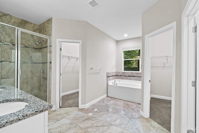 bathroom featuring vanity and shower with separate bathtub