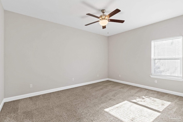 spare room featuring carpet flooring and ceiling fan