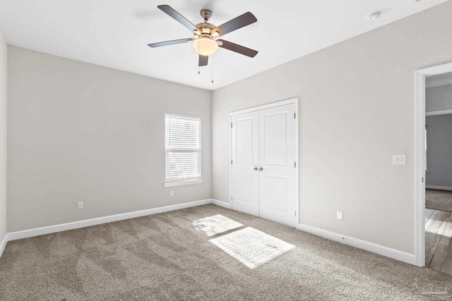 unfurnished bedroom with ceiling fan, carpet floors, and a closet