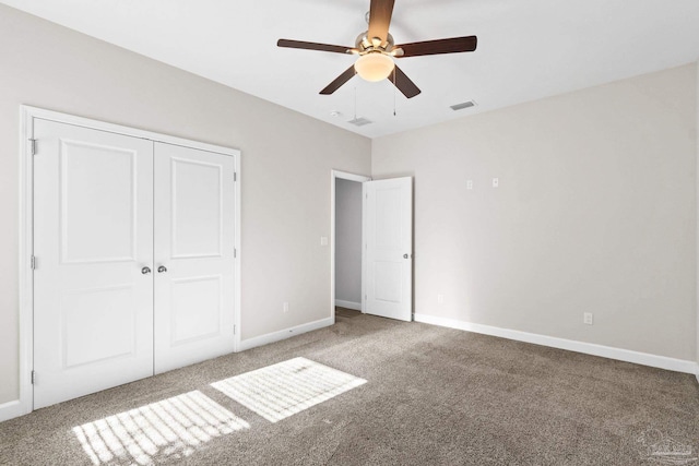 unfurnished bedroom featuring carpet flooring, ceiling fan, and a closet