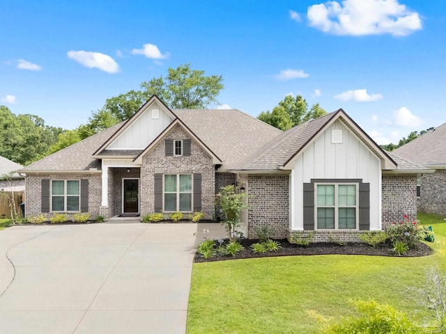 1604 Cadence Loop, Cantonment, FL 32533 - view of front of house featuring board and batten siding, brick siding, a front lawn, and driveway
