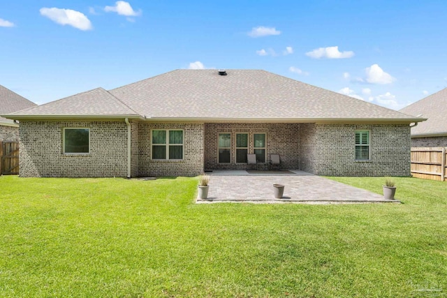 1604 Cadence Loop, Cantonment, FL 32533 - rear view of house with roof with shingles, brick siding, and a patio