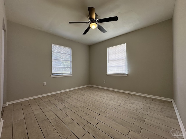 empty room with ceiling fan and light wood-type flooring