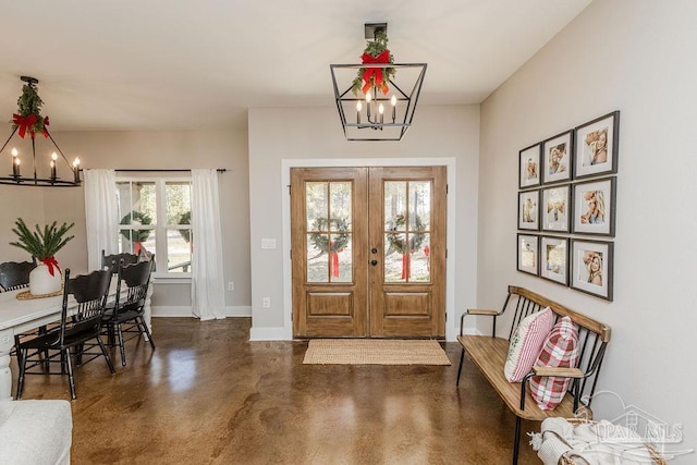 foyer with french doors and an inviting chandelier