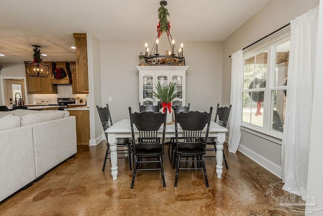 dining room featuring sink and an inviting chandelier