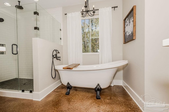 bathroom with shower with separate bathtub and a notable chandelier