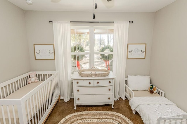 bedroom with ceiling fan and dark carpet