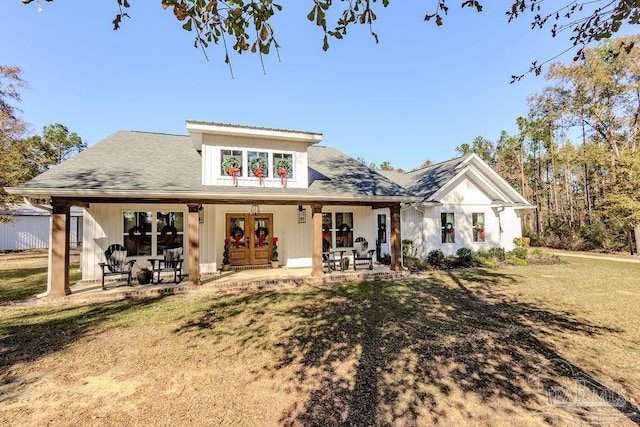 rear view of house with a lawn and french doors