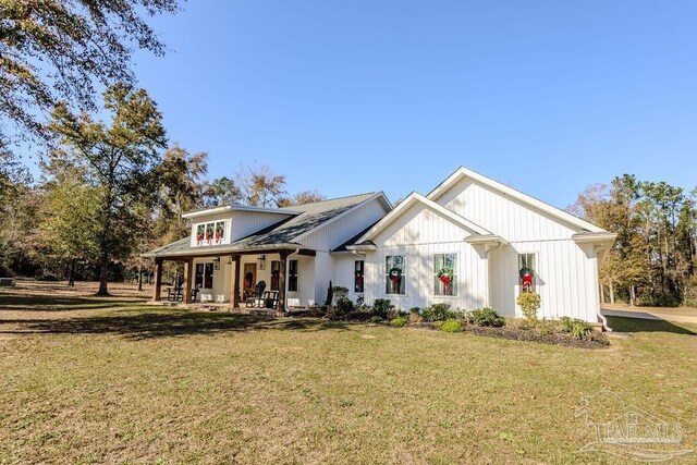 modern inspired farmhouse featuring a porch and a front lawn