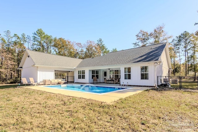 rear view of property featuring a patio area, ceiling fan, a yard, and pool water feature