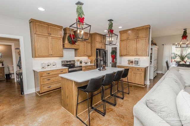 kitchen featuring appliances with stainless steel finishes, custom exhaust hood, a breakfast bar, a kitchen island with sink, and pendant lighting