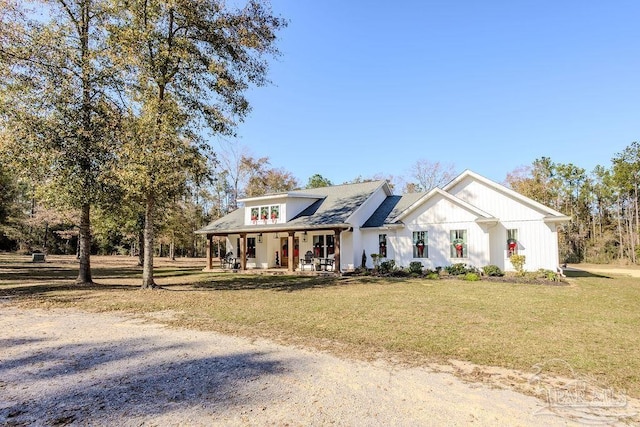 modern inspired farmhouse with a front yard and a porch