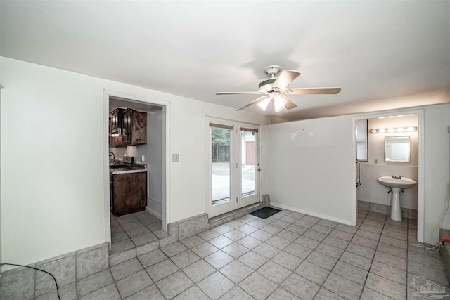 spare room featuring ceiling fan, light tile patterned flooring, and sink