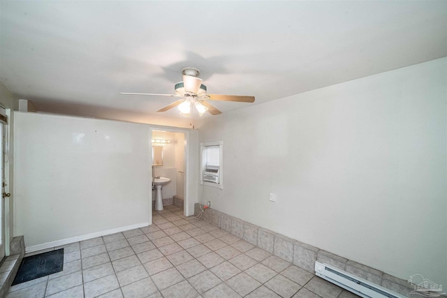 spare room with ceiling fan, sink, and a baseboard heating unit