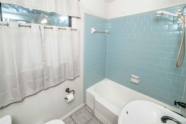 bathroom with tile patterned flooring and tiled shower / bath