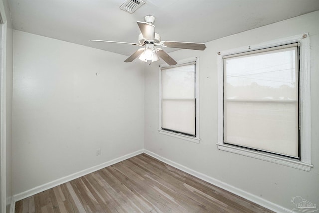 spare room with ceiling fan and light wood-type flooring