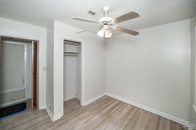 unfurnished bedroom with a closet, light hardwood / wood-style flooring, and ceiling fan