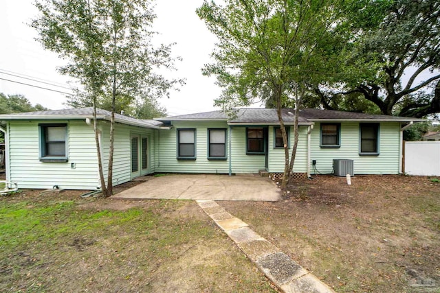 view of front of house with central AC and a patio