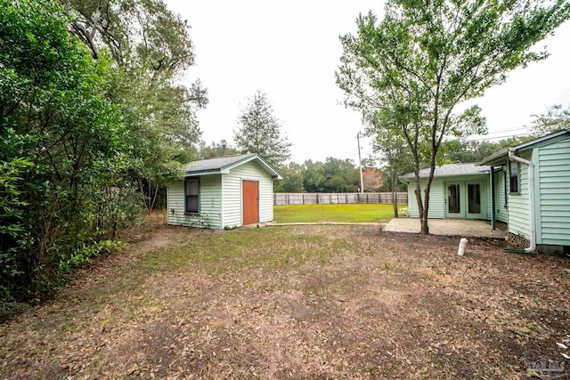 view of yard with a patio and a storage unit