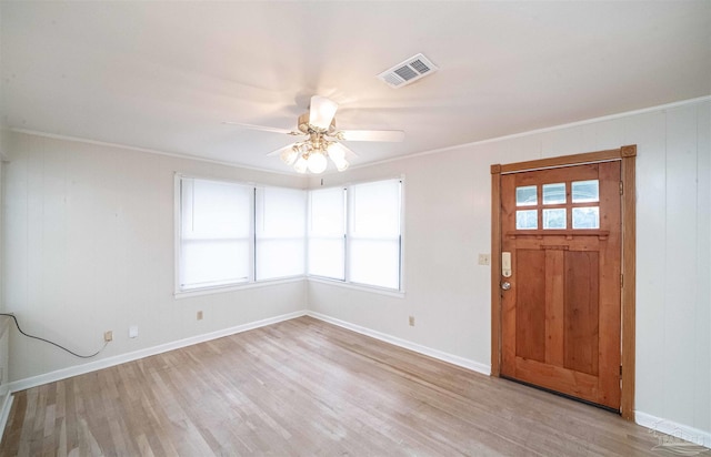 entryway with light hardwood / wood-style flooring, ceiling fan, and crown molding