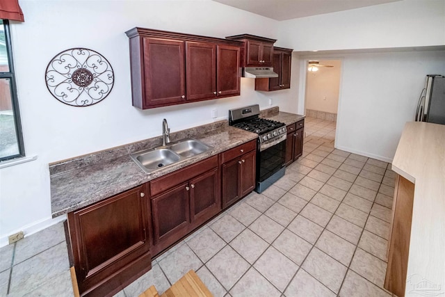 kitchen with appliances with stainless steel finishes, light tile patterned floors, ceiling fan, and sink