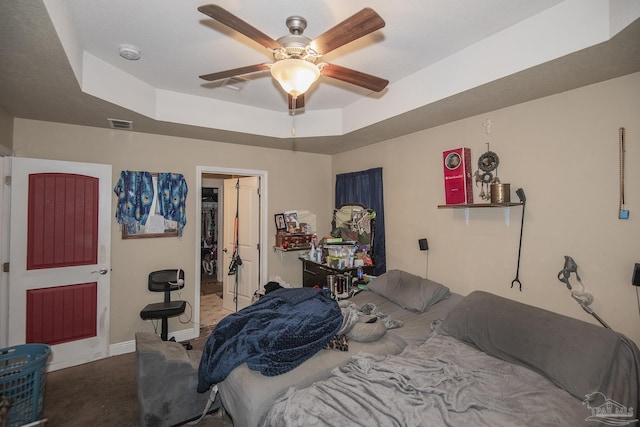 5800 Providence Loop, Pensacola, FL 32526 - carpeted bedroom with a tray ceiling, a spacious closet, ceiling fan, and a closet