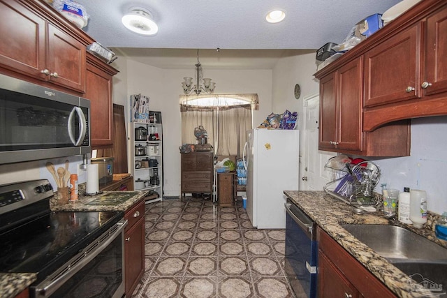 5800 Providence Loop, Pensacola, FL 32526 - kitchen featuring appliances with stainless steel finishes, a sink, reddish brown cabinets, and a chandelier