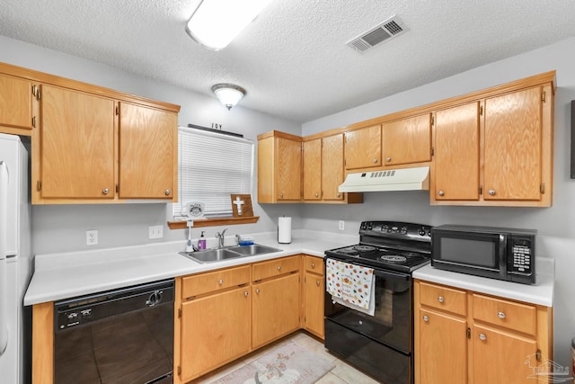 kitchen featuring light tile patterned floors, a textured ceiling, black appliances, and sink